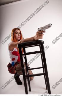 27 2018 01 TINA KNEELING POSE WITH GUNS